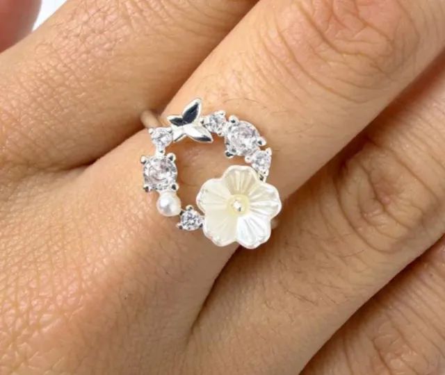Anillo circular con mariposa y flor